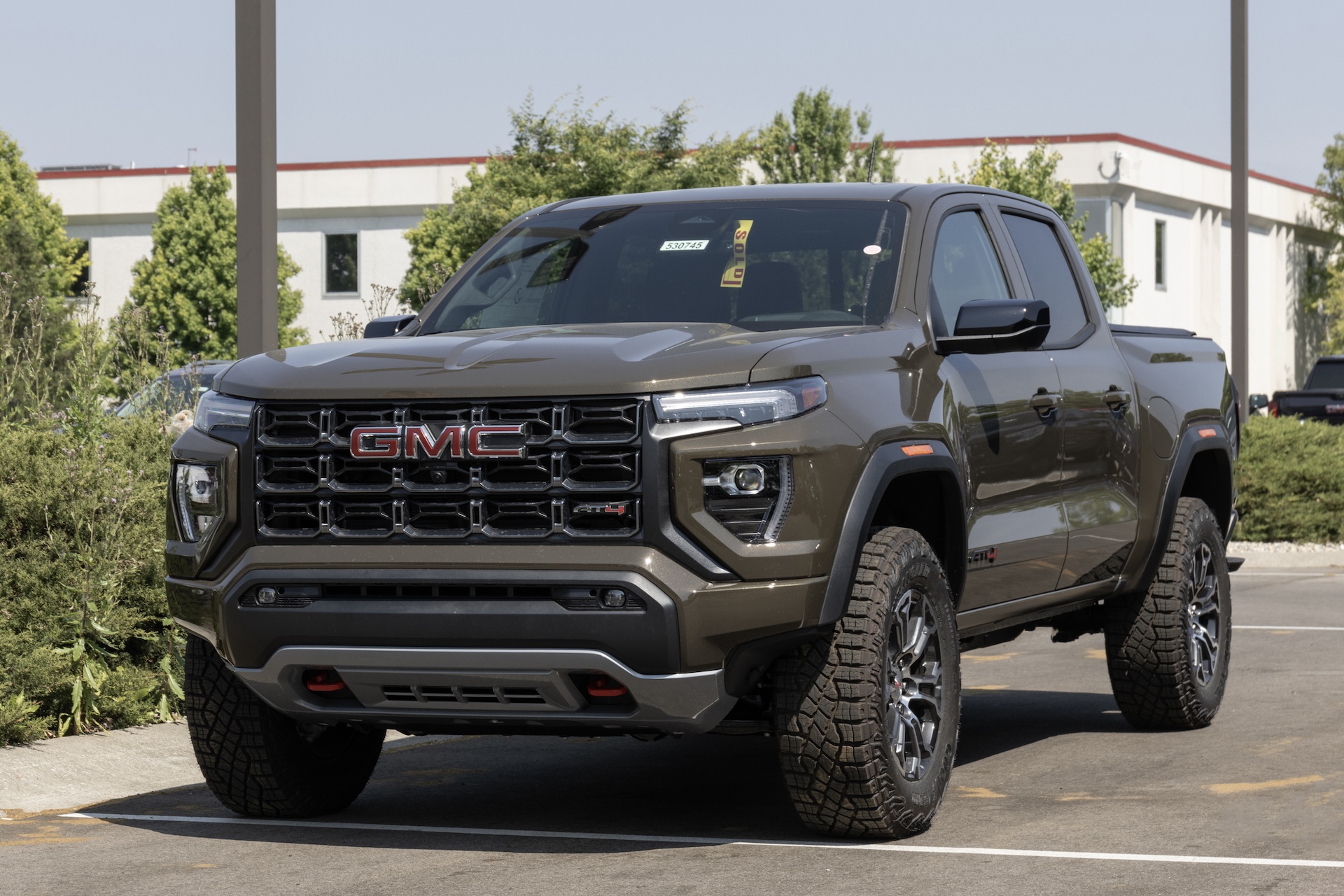 GMC Canyon AT4 pickup display at a dealership. GMC offers the Canyon in Elevation Standard, Elevation, and Denali models.