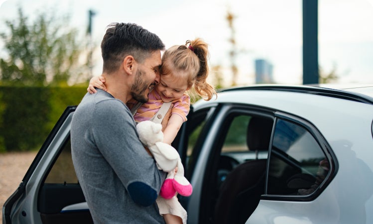 Father and daughter exiting vehicle