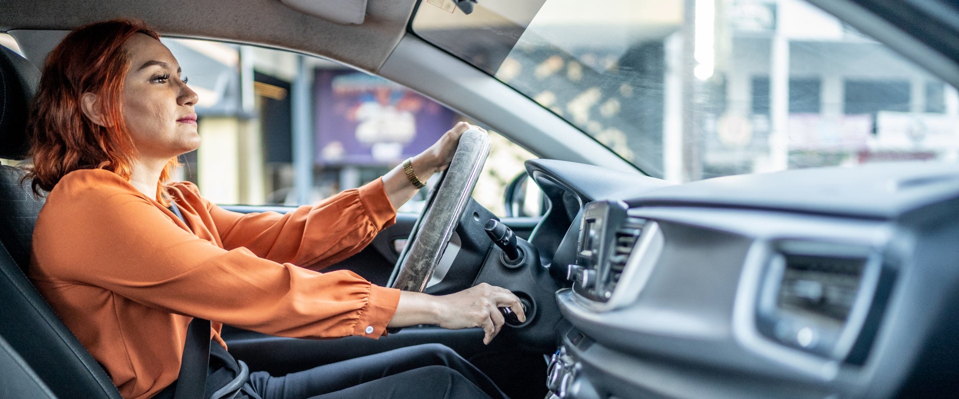 Lady driving away in her new car